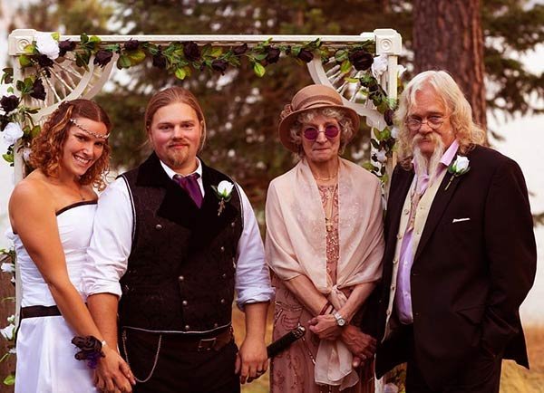 Image of Caption: Noah and his wife posed for a photograph with Billy and Ami Brown on their wedding